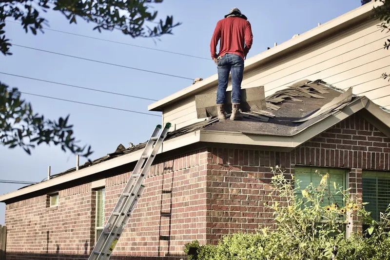 Professional roofer working on a residential roof in Brownlee Estates